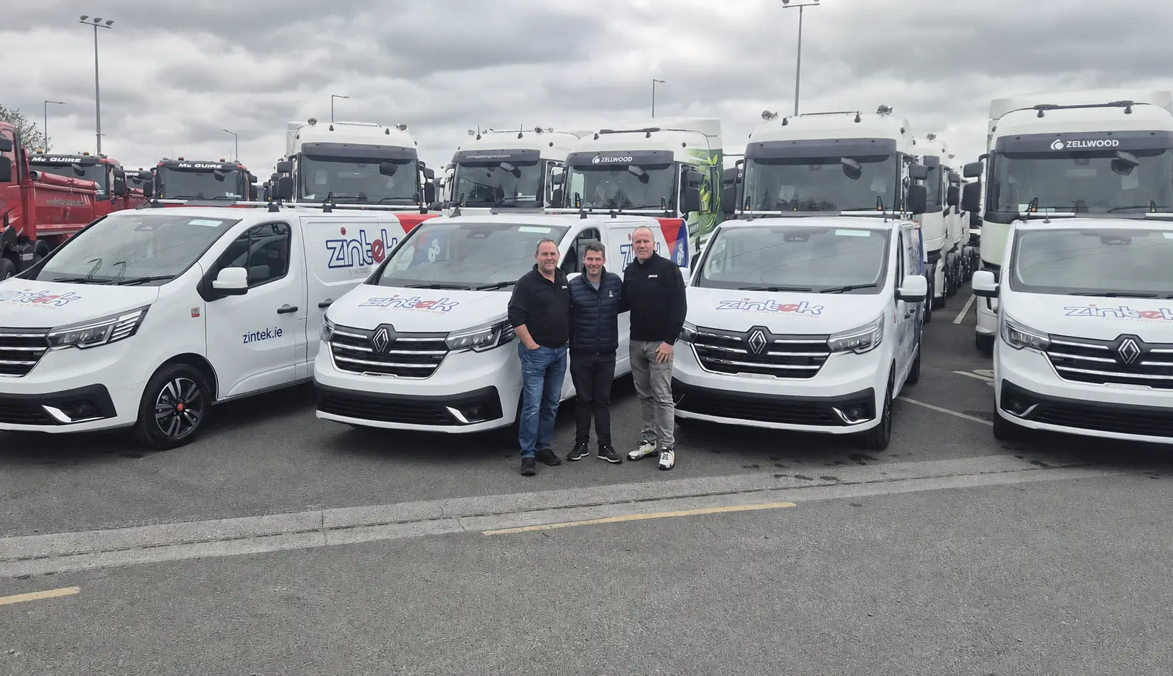Zintek team standing beside branded service vans for field support operations